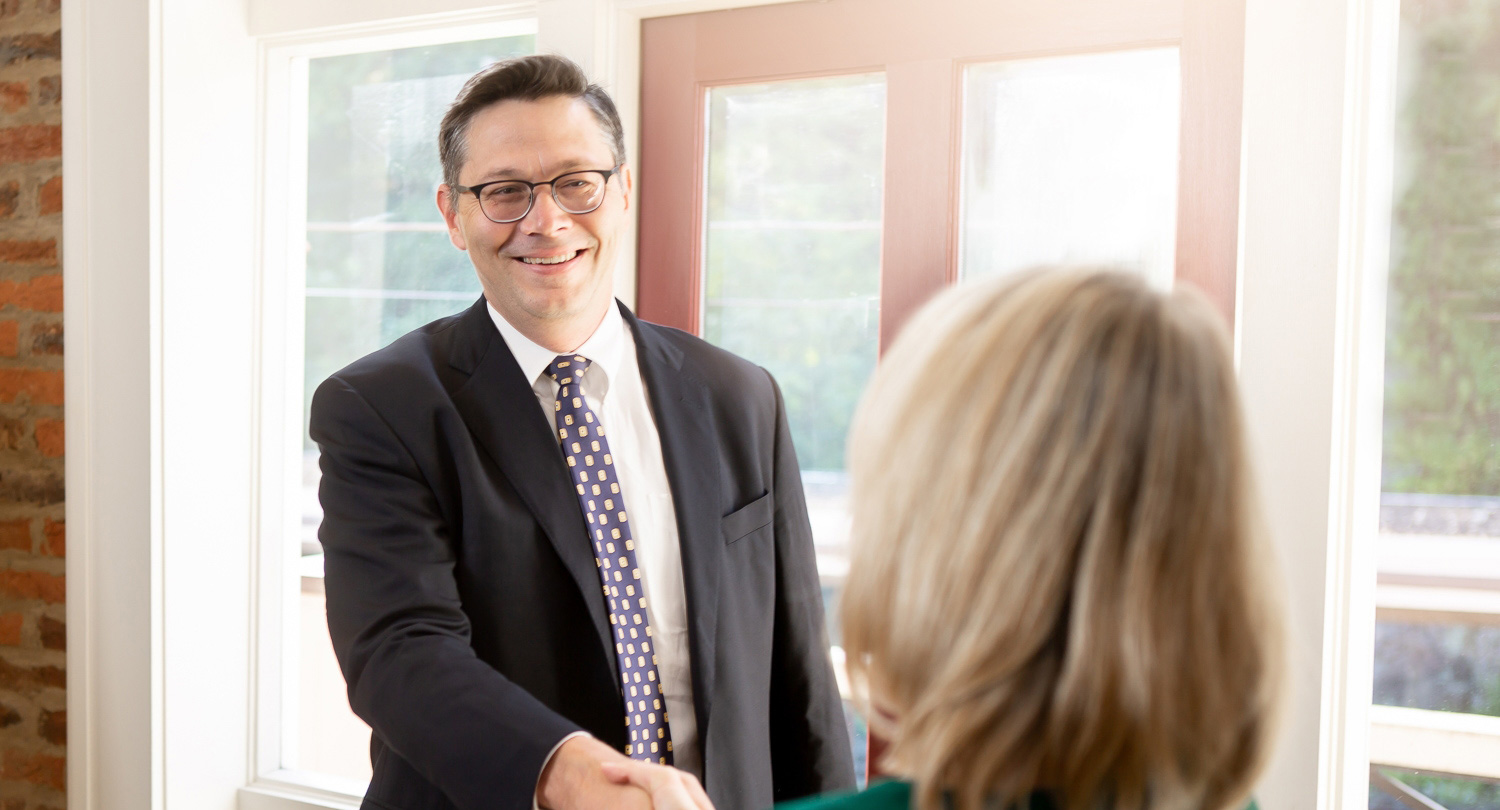 estate planning attorney shaking hands with client